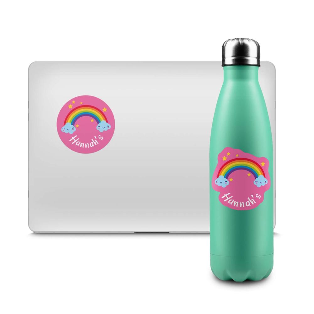 Personalised rainbow emoji sticker with name applied to a silver laptop and teal reusable bottle